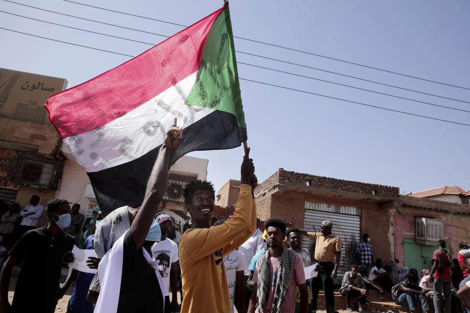 People chant slogans during a demonstration against the killing of dozens by Sudanese security forces since a military coup three months ago, in Khartoum, Sudan, Monday, Jan. 24, 2022. (AP Photo/Marwan Ali)