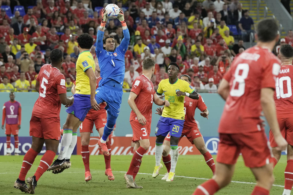 Switzerland's goalkeeper Yann Sommer, top, catches the ball during the World Cup group G soccer match between Brazil and Switzerland at the Stadium 974 in Doha, Qatar, Monday, Nov. 28, 2022. (AP Photo/Hassan Ammar)