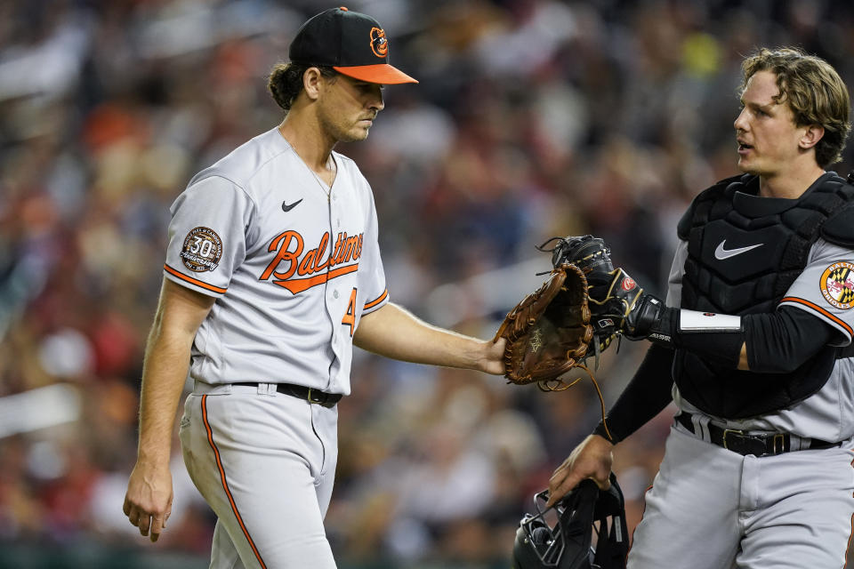 Baltimore Orioles starting pitcher Dean Kremer, left, reacts with catcher Adley Rutschman after the fifth inning of the team's baseball game against the Washington Nationals at Nationals Park, Tuesday, Sept. 13, 2022, in Washington. (AP Photo/Alex Brandon)