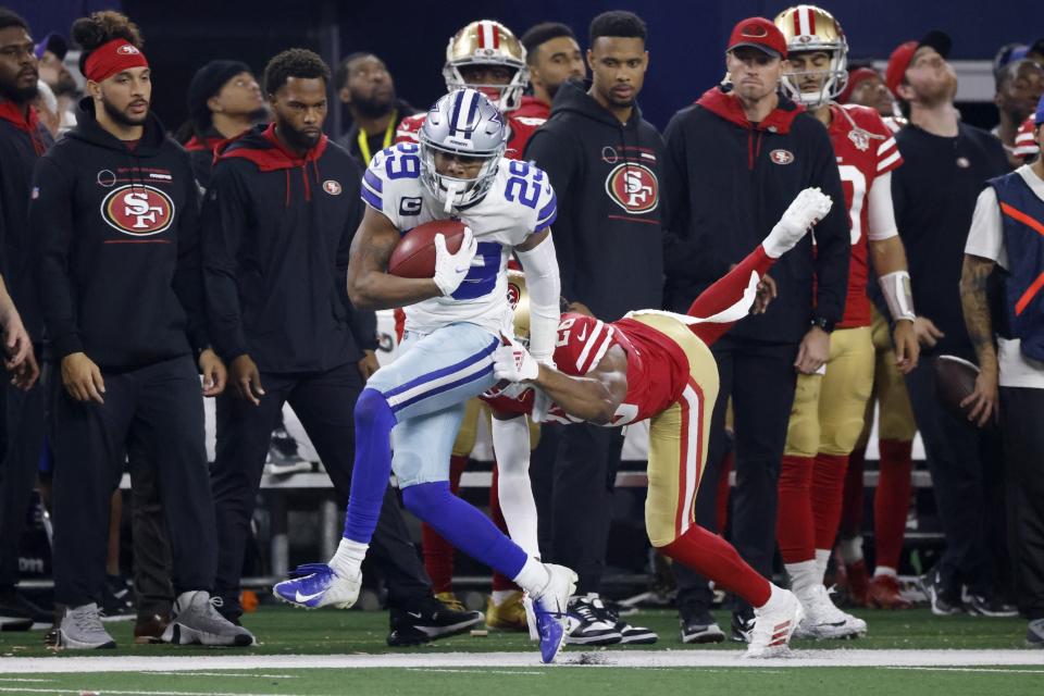 Dallas Cowboys defensive back C.J. Goodwin (29) catches a pass on a punt fake play as San Francisco 49ers cornerback Josh Norman (26) defends in the second half of an NFL wild-card playoff football game in Arlington, Texas, Sunday, Jan. 16, 2022. (AP Photo/Ron Jenkins)