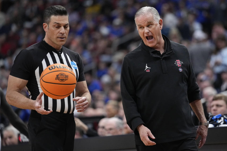 San Diego State head coach Brian Dutcher speaks with an official in the first half of a Elite 8 college basketball game against Creighton in the South Regional of the NCAA Tournament, Sunday, March 26, 2023, in Louisville, Ky. (AP Photo/John Bazemore)