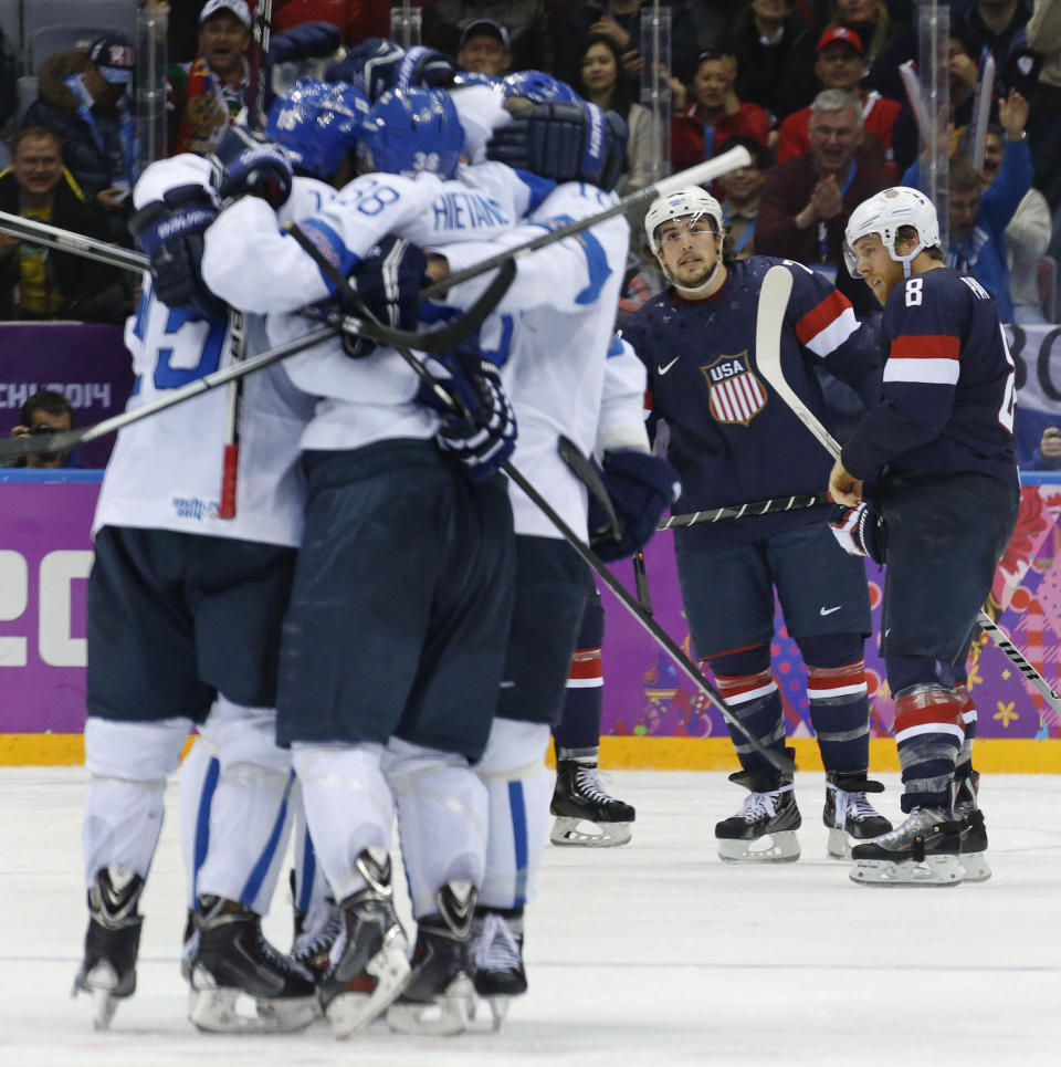 USA defenseman Justin Faulk and forward Joe Pavelski react as Finland celebrates a goal during the third period of the men's bronze medal ice hockey game at the 2014 Winter Olympics, Saturday, Feb. 22, 2014, in Sochi, Russia. (AP Photo/Mark Humphrey)