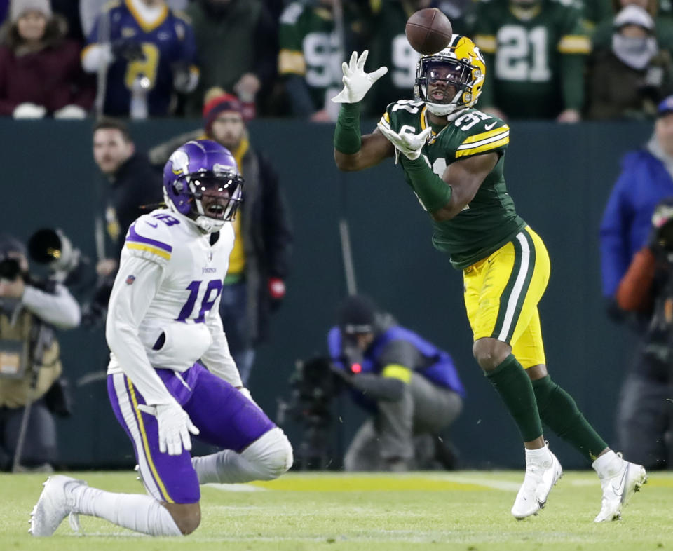 Jan 1, 2023; Green Bay, Wisconsin, USA; Green Bay Packers safety Adrian Amos (31) makes a second quarter interception against the Minnesota Vikings during their football game at Lambeau Field. Mandatory Credit: Wm. Glasheen-USA TODAY Sports