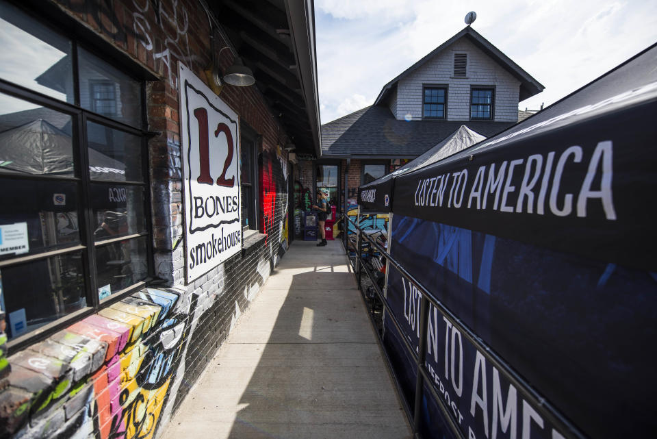 A sign&nbsp;for 12 Bones Smokehouse appears across from&nbsp;the HuffPost video activation site in Asheville.