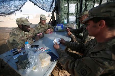 U.S. soldiers from the 2nd Brigade, 82nd Airborne Division play poker at a military base north of Mosul, Iraq, February 14, 2017. Picture taken February 14, 2017. REUTERS/Khalid al Mousily