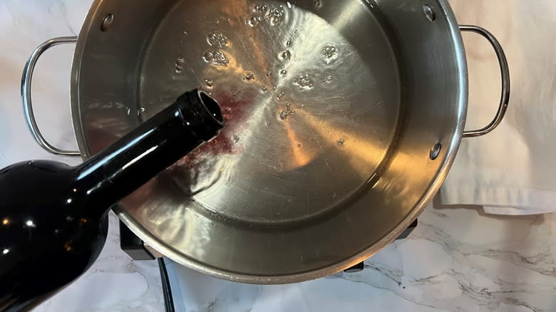 pouring wine into pot of sugar water