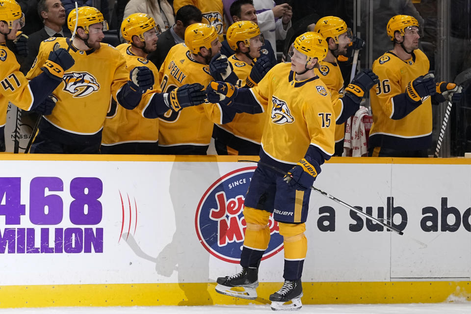 Nashville Predators center Juuso Parssinen (75) celebrates a goal with teammates during the first period of an NHL hockey game against the Tampa Bay Lightning, Thursday, Dec. 7, 2023 in Nashville, Tenn. (AP Photo/George Walker IV)