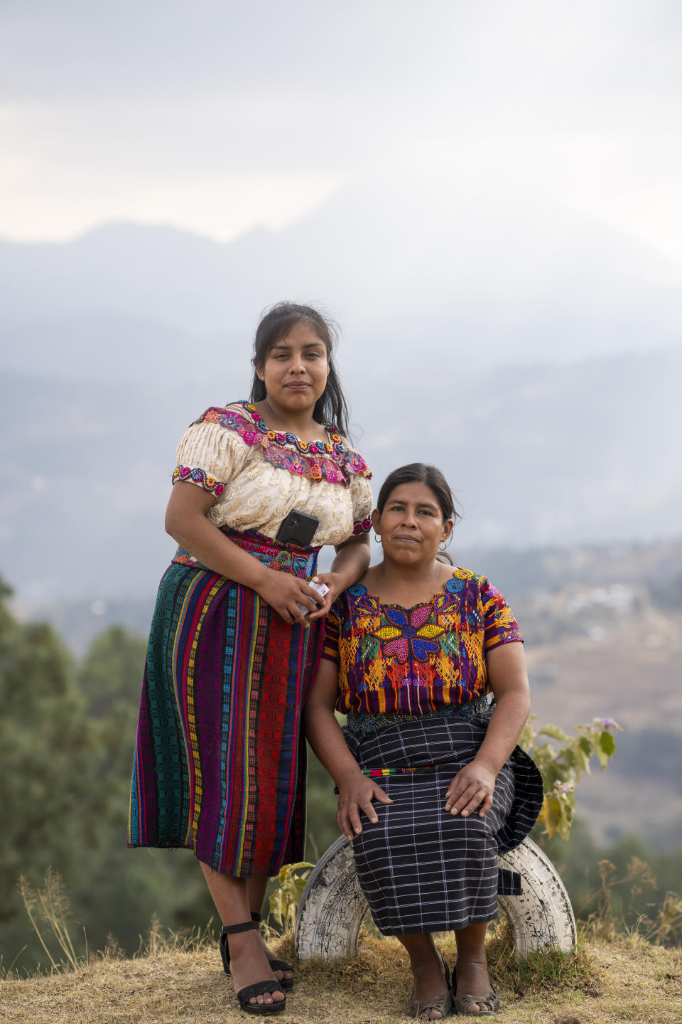 Filomena Crisostomo Miranda, right, and her daughter Glendy Aracely pose for a portrait in the Loma Linda hamlet of Comitancillo, Guatemala, Monday, March 18, 2024. Glendy is planning to migrate to the U.S., despite the death of her 23-year-old sister Blanca who died on her third attempt to reach the U.S., asphyxiated alongside 50 other migrants in a smuggler’s tractor-trailer in San Antonio, Texas in June 2022. (AP Photo/Moises Castillo)