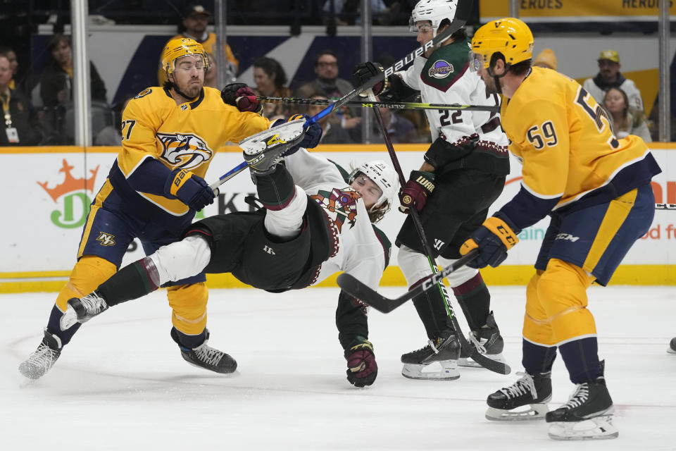 Nashville Predators' Ryan McDonagh (27) checks Arizona Coyotes' Liam O'Brien (38) to the ice in the first period of an NHL hockey game Monday, Nov. 21, 2022, in Nashville, Tenn. (AP Photo/Mark Humphrey)