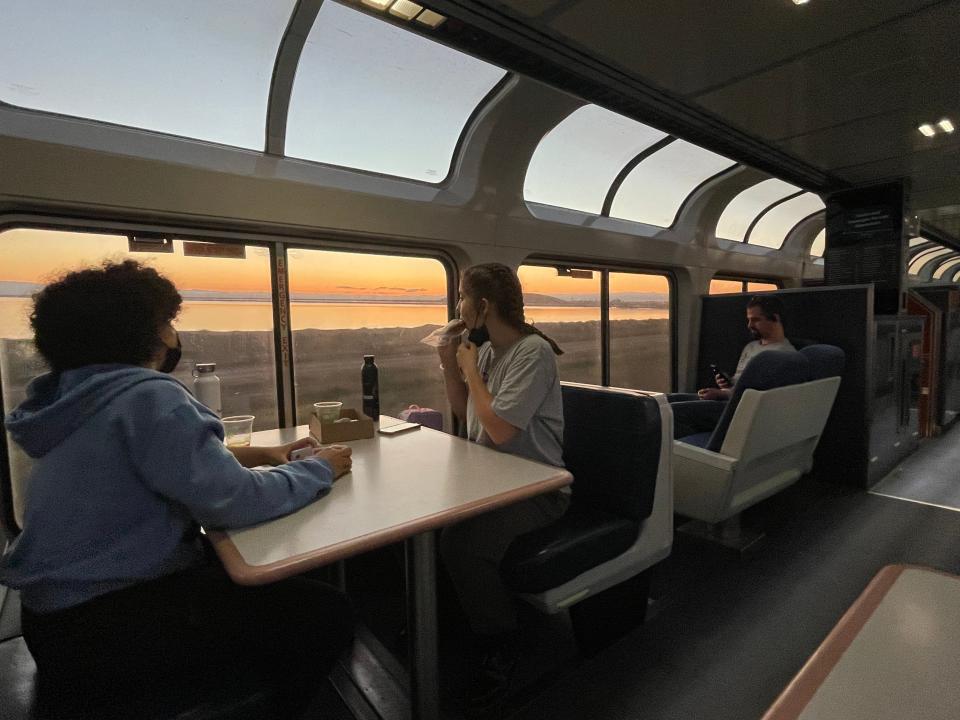 amtrak train car with windows and dining tables