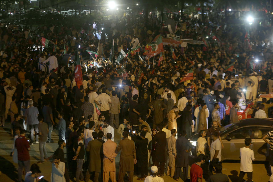 Supporters of former Pakistani Prime Minister Imran Khan's 'Pakistan Tehreek-e-Insaf' party block a road as protest against against provincial assembly's deputy speaker, Dost Mohammad Mazari for his ruling to invalidate 10 votes in the chief minister elections, in Lahore, Pakistan, Friday, July 22, 2022. Former Pakistani Prime Minister Imran Khan's party was sidelined in a key vote Friday in the local assembly in Punjab province, despite winning there earlier this week. Khan slammed the development and called on his supporters to rally across Pakistan. (AP Photo/K.M. Chaudary)