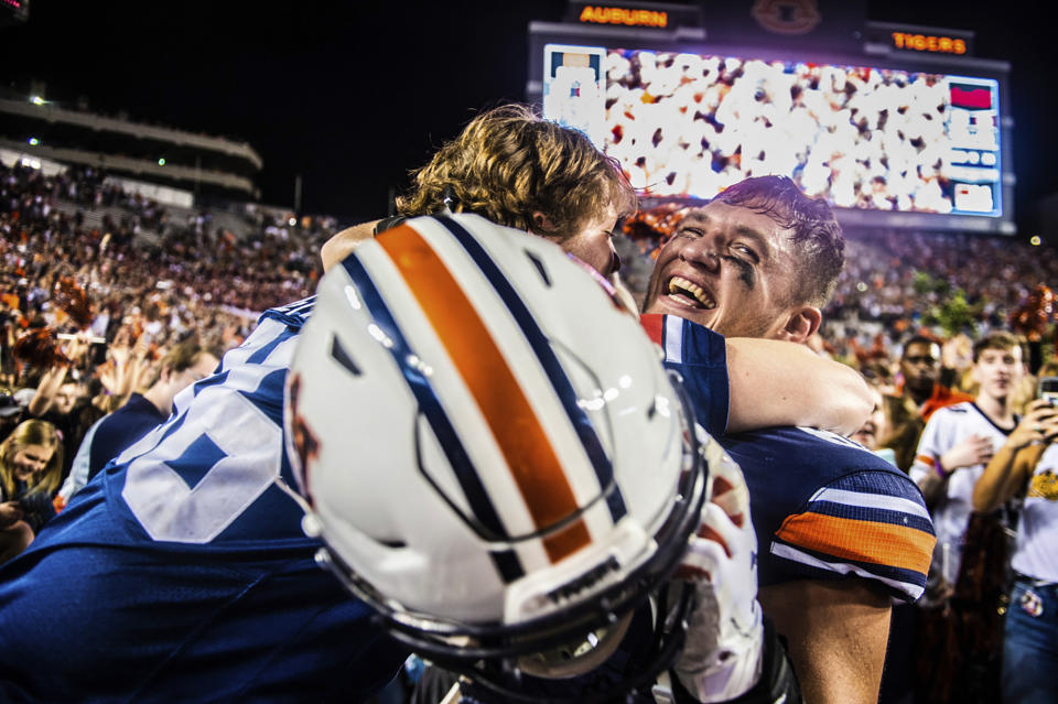 Auburn tight end Phelps Gambill (89) celebrates with a fan after the team defeated Alabama 48-45 in an NCAA college football game, Saturday, Nov. 30, 2019, in Auburn, Ala. (Dan Busey/The Decatur Daily via AP)