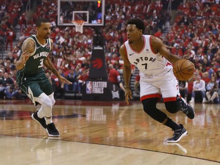 May 21, 2019; Toronto, Ontario, CAN; Toronto Raptors guard Kyle Lowry (7) dribbles the ball past Milwaukee Bucks guard George Hill (3) during game four of the Eastern conference finals of the 2019 NBA Playoffs at Scotiabank Arena. Mandatory Credit: John E. Sokolowski-USA TODAY Sports