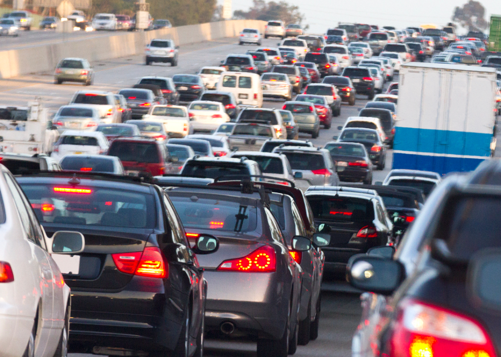 View of back of many cars on a congested highway. 