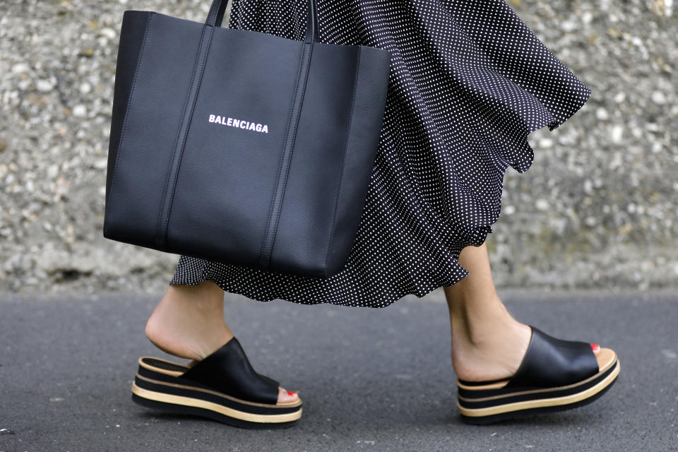 WUERZBURG, GERMANY - MAY 21: Fashion designer Eva Lutz, wearing a black dress with white polka dots by Alice + Olivia, a black shopper bag by Balenciaga and black platform sandals by Paloma Barcelo during a street style shooting on May 21, 2020 in Wuerzburg, Germany. (Photo by Streetstyleograph/Getty Images)