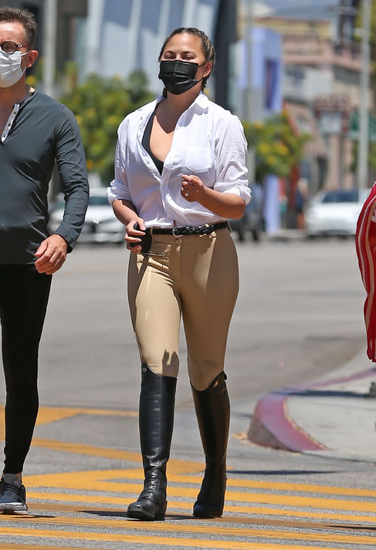 Chrissy Teigen is seen wearing riding pants and boots while out shopping on Melrose in Los Angeles, July 20. - Credit: carlosmaidanaphotography/MEGA