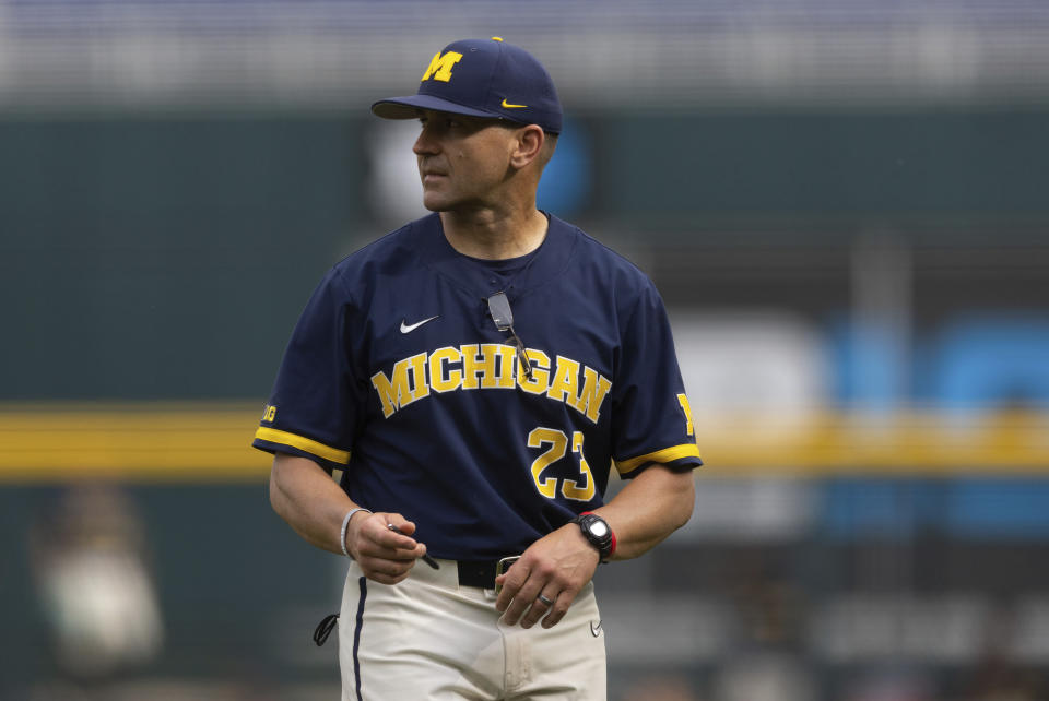 Michigan head coach Erik Bakich returns to the dugout after arguing with the umpires following a play at first base against Rutgers in the first inning of the NCAA college Big Ten baseball championship game Sunday, May 29, 2022, at Charles Schwalb Field in Omaha, Neb. (AP Photo/Rebecca S. Gratz)