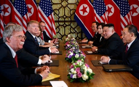 President Donald Trump speaks during a meeting with North Korean leader Kim Jong Un Thursday, Feb. 28, 2019, in Hanoi. At front right is Kim Yong Chol, a North Korean senior ruling party official and former intelligence chief. At left is national security adviser John Bolton. - Credit: AP