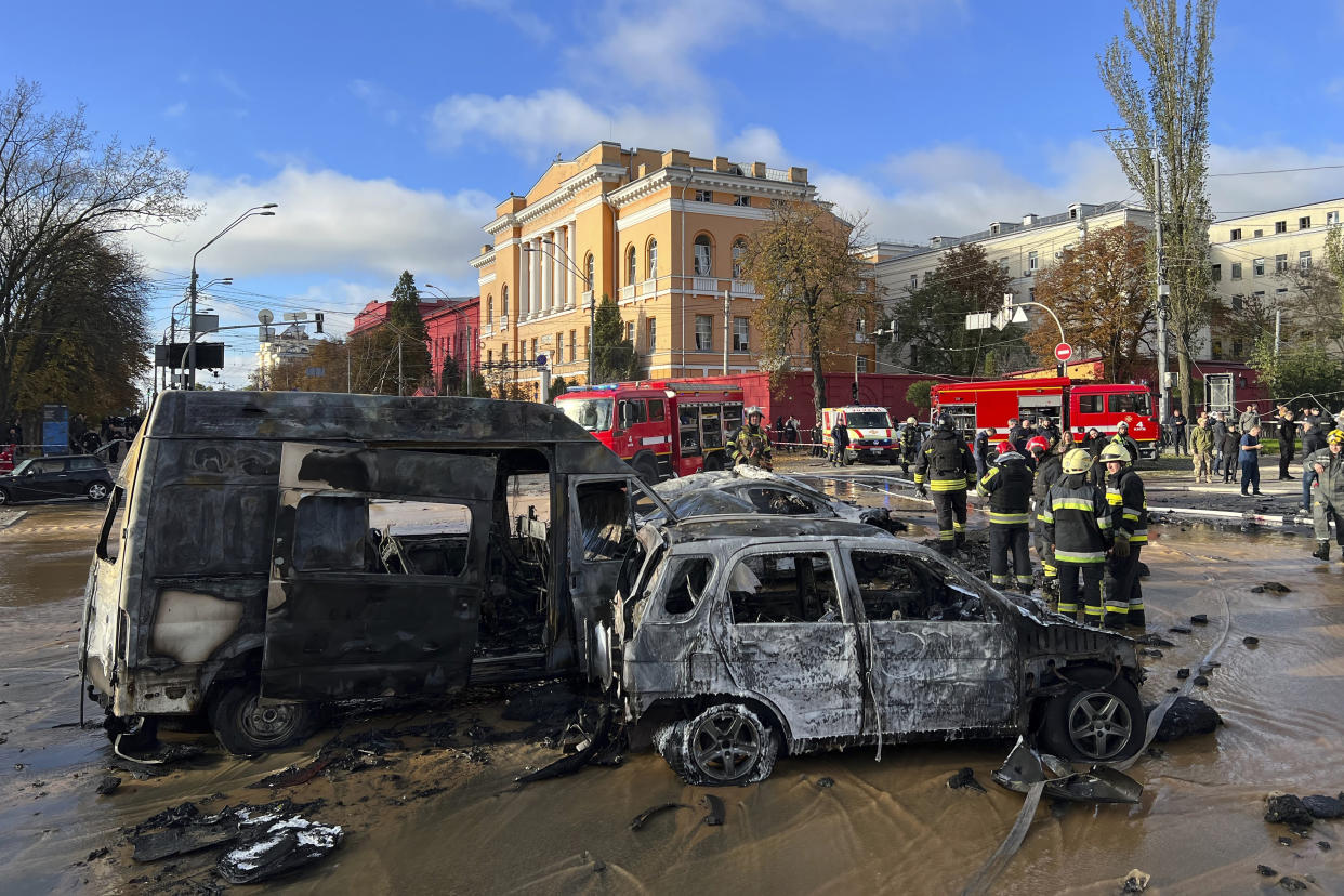 FILE - Rescue workers survey the scene of a Russian attack on Kyiv, Ukraine on Monday, Oct. 10, 2022. Russia has declared its intention to increase its targeting of Ukraine’s power, water and other vital infrastructure in its latest phase of the nearly 8-month-old war. (AP Photo/Adam Schreck, File)