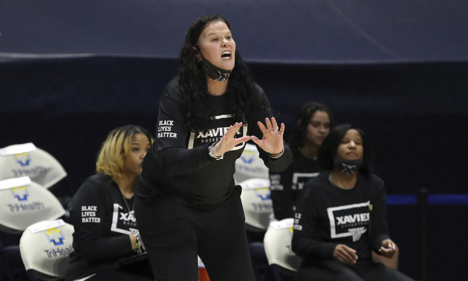 Xavier head coach Melanie Moore gives instructions during the first half of an NCAA college basketball game against Connecticut, Saturday, Feb. 20, 2021, in Cincinnati. (AP Photo/Gary Landers)