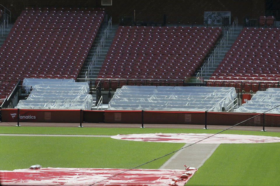 Empty seats are seen seen inside Busch Stadium, home of the St. Louis Cardinals baseball team, Wednesday, March 25, 2020, in St. Louis. The start of the regular season, which was set to start on Thursday, is on hold indefinitely because of the coronavirus pandemic. (AP Photo/Jeff Roberson)