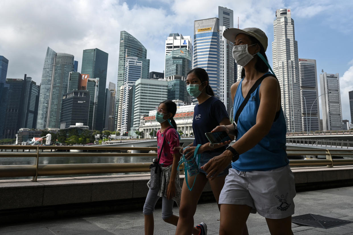 People seen walking along Marina Bay promenade on 17 March. (PHOTO: Getty Images)