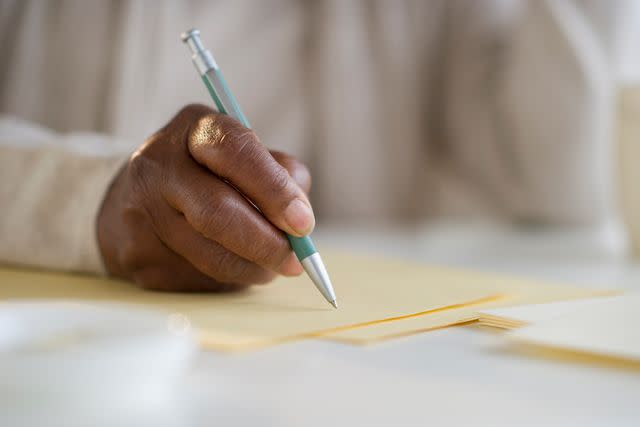 <p>Getty</p> Woman writing list