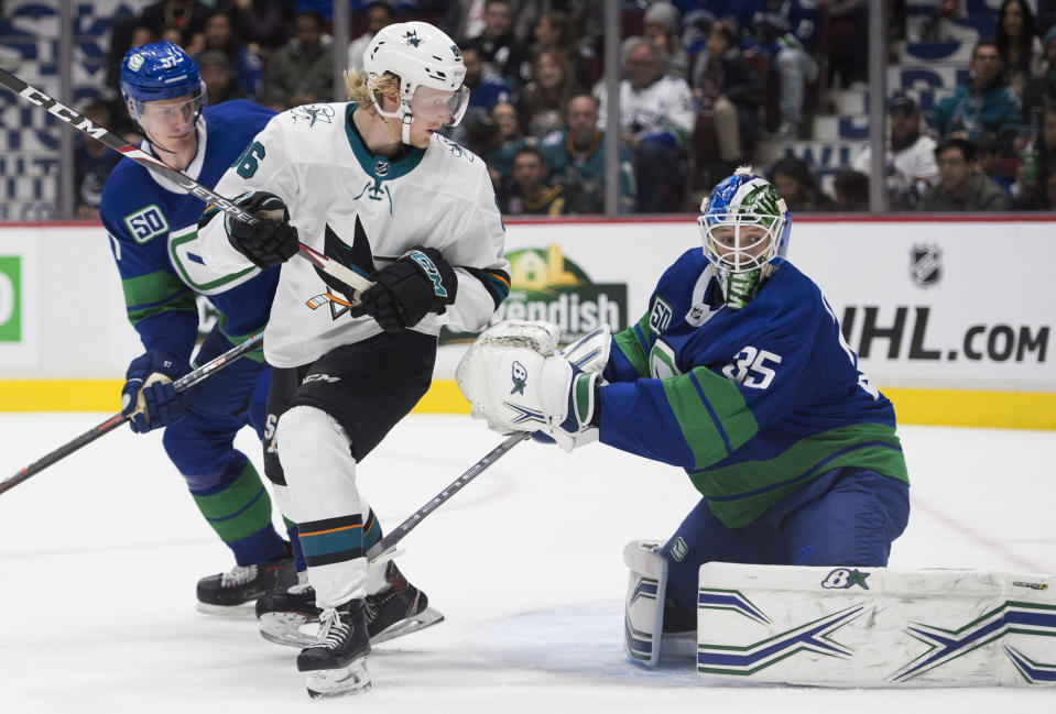 San Jose Sharks right wing Joachim Blichfeld (86) fails to get a shot past Vancouver Canucks goaltender Thatcher Demko (35) during the third period of an NHL hockey game in Vancouver, British Columbia, Saturday, Jan. 18, 2020. Vancouver Canucks defenseman Tyler Myers, left, watches the play. (Jonathan Hayward/The Canadian Press via AP)