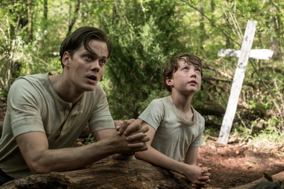 The Devil All The Time (L-R) Bill Skarsgård as Willard Russell, Michael Banks Repeta as Arvin Russell (9 Years Old). (Glen Wilson/Netflix © 2020)