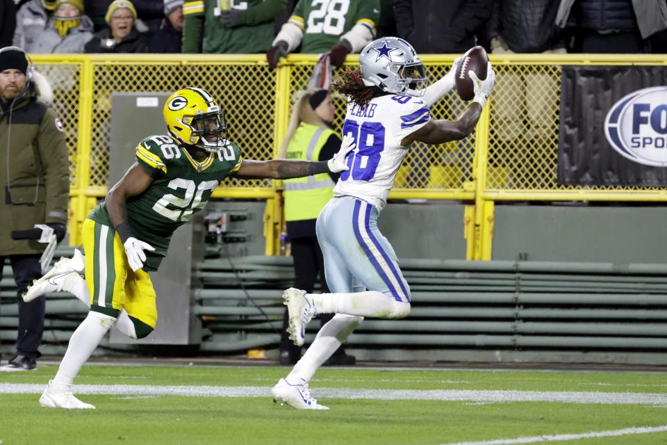 Dallas Cowboys wide receiver CeeDee Lamb (88) catches a pass for a touchdown as Green Bay Packers cornerback Keisean Nixon (25) defends during the second half of an NFL football game Sunday, Nov. 13, 2022, in Green Bay, Wis. (AP Photo/Mike Roemer)