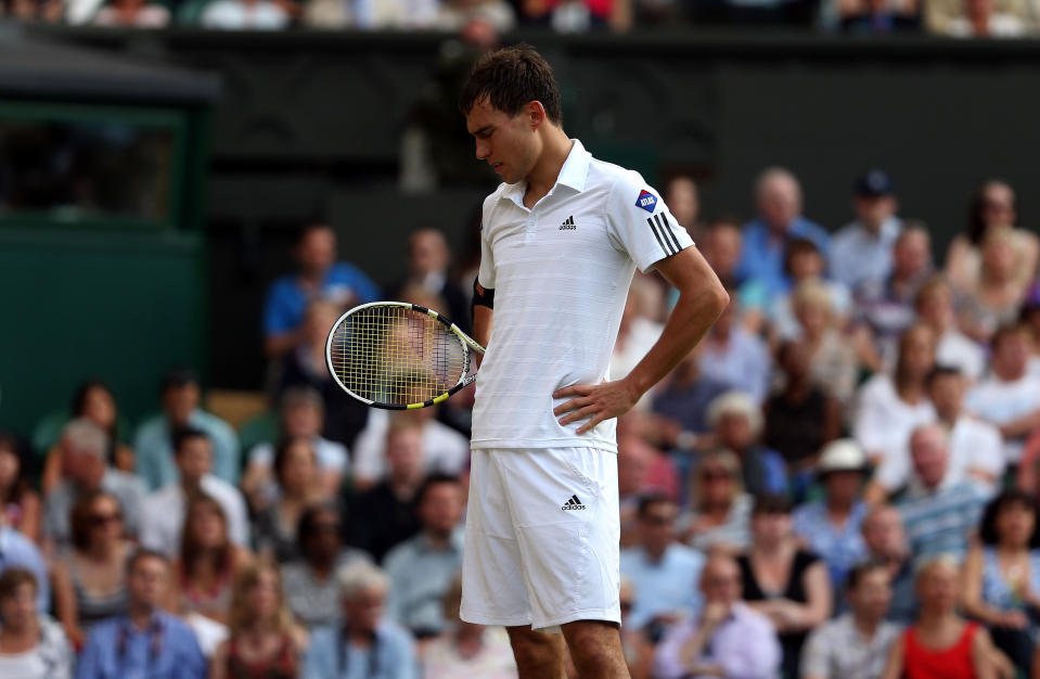 Poland's Jerzy Janowicz stands dejected during his match against Great Britain's Andy Murray during day eleven of the Wimbledon Championships at The All England Lawn Tennis and Croquet Club, Wimbledon.