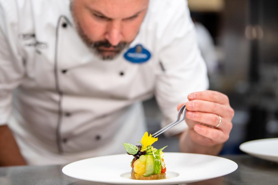 Victoria & Albert’s chef de cuisine Matthew Sowers puts the finishing touches on a dish at the culinary crown jewel of Walt Disney World Resort.