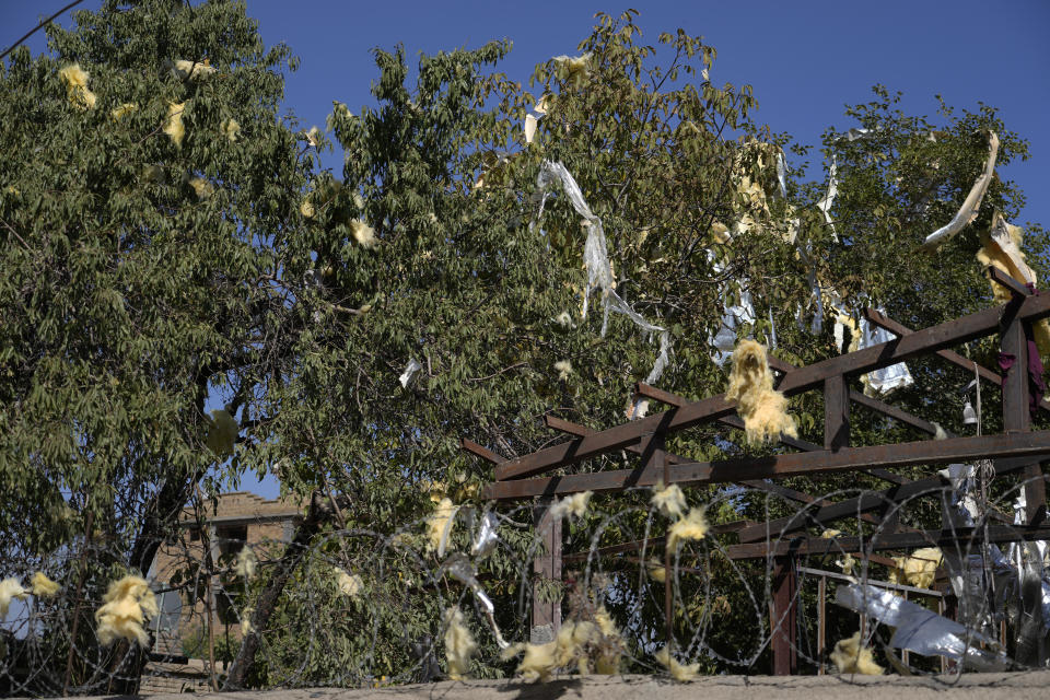 A view of the trees of an education center that was attacked by a suicide bomber, in Kabul, Afghanistan, Friday, Sept. 30, 2022. A Taliban spokesman says a suicide bomber has killed several people and wounded others at an education center in a Shiite area of the Afghan capital. The bomber hit while hundreds of teenage students inside were taking practice entrance exams for university, a witness says. (AP Photo/Ebrahim Noroozi)