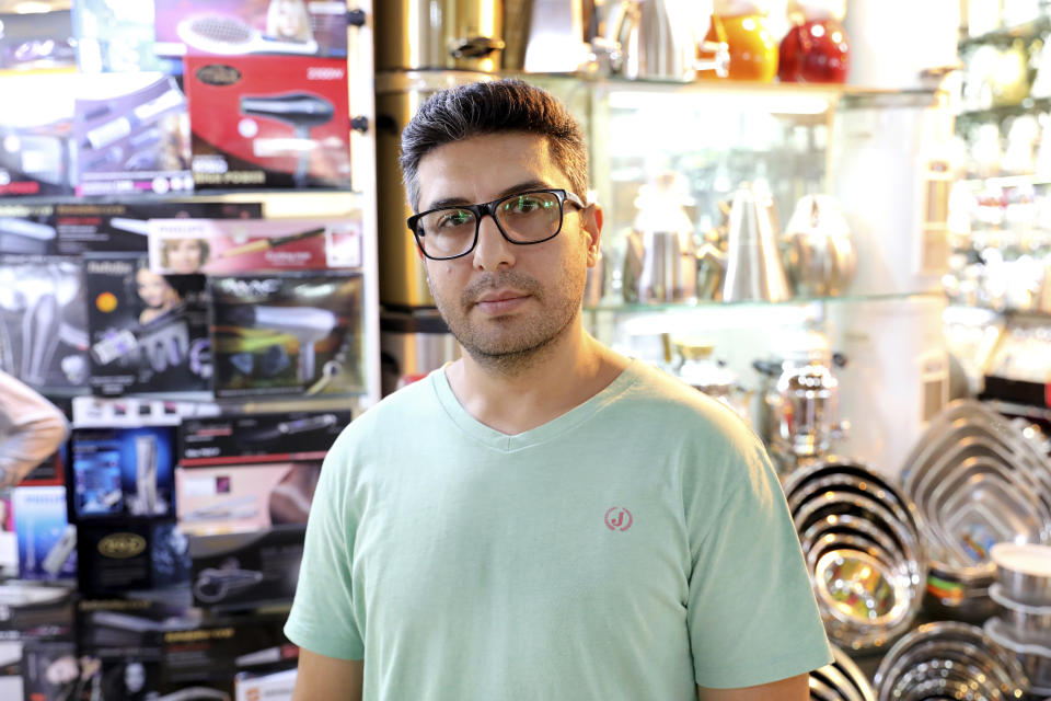 Mehdi Hamzeh Nia, a 39-year-old appliance salesman, is interviewed by The Associated Press at the old main bazaar in Tehran, Iran, Tuesday, July 2, 2019. While opinions differ across Tehran's Grand Bazaar about the ongoing tensions between the U.S. and Iran over its unraveling nuclear deal, there's one thing those in the beating heart of Iran's capital city agree on: American sanctions hurt the average person, not those in charge. (AP Photo/Ebrahim Noroozi)