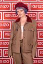 <p>Maisie Williams rocks purple hair and bleached eyebrows as she attends the Kenzo Party as part of Paris Fashion Week on Sept. 30 in France.</p>