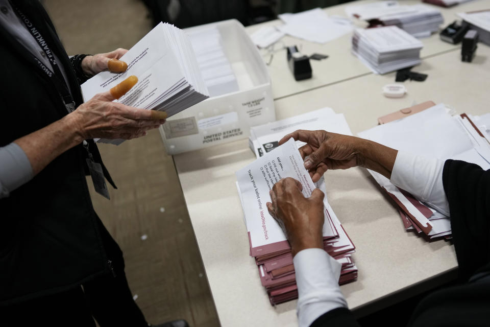 Election officials Edith Ruth Sims, right, and Linda Sharritt, left, as part of a bipartisan team, process ballots on Election Day at the Franklin County Board of Elections in Columbus, Ohio, Tuesday, Nov. 7, 2023. Polls are open in a few states for off-year elections that could give hints of voter sentiment ahead of next year's critical presidential contest. (AP Photo/Carolyn Kaster)