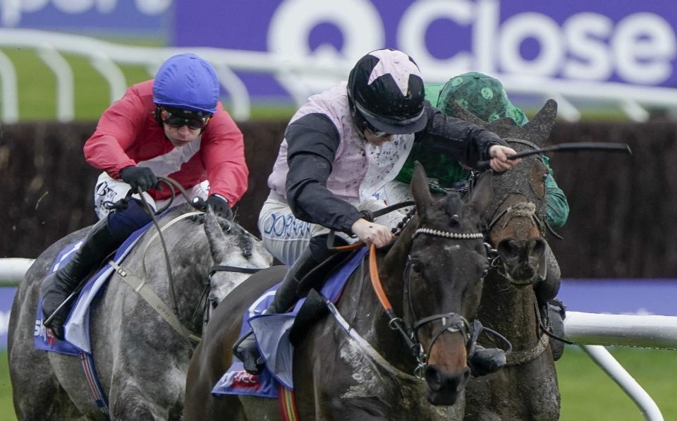 Rachael Blackmore riding Slade Steel (pink/white/black) clear the last to win The Sky Bet Supreme Novices' Hurdle