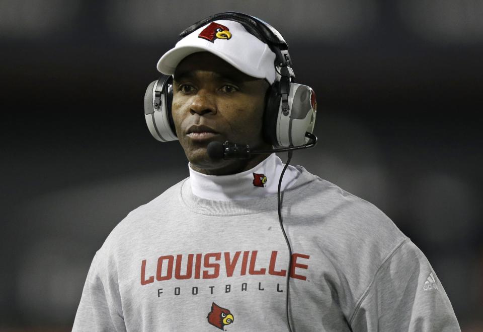 FILE - In tihs Dec. 5, 2013, file photo, Louisville head coach Charlie Strong watches from the sidelines in the first half of an NCAA college football game against Cincinnati in Cincinnati. Strong remains Louisville's football coach for the moment, telling assistants Saturday morning, Jan. 4, 2014, he hasn't decided to accept Texas' offer to become its coach. (AP Photo/Al Behrman, File)