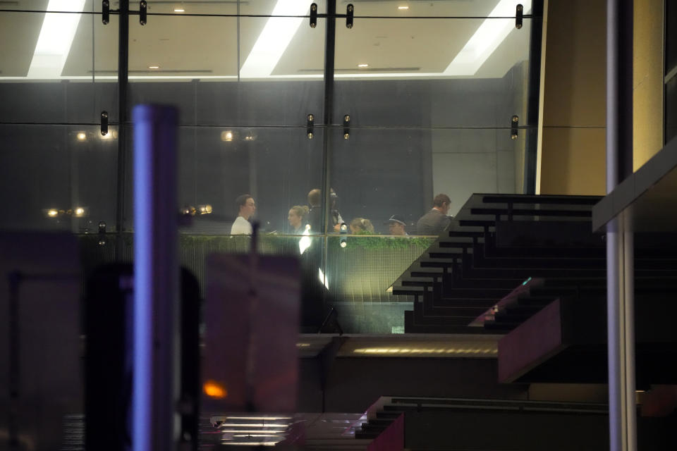 Investigators and others are seen inside Westfield Shopping Centre, where multiple people were stabbed in Sydney, Saturday, April 13, 2024. The Sydney Morning Herald reported that four people died in the stabbing. Police couldn't be immediately reached to confirm the report. The newspaper said one person was also shot, but it wasn't clear if the person had died.(AP Photo/Rick Rycroft)