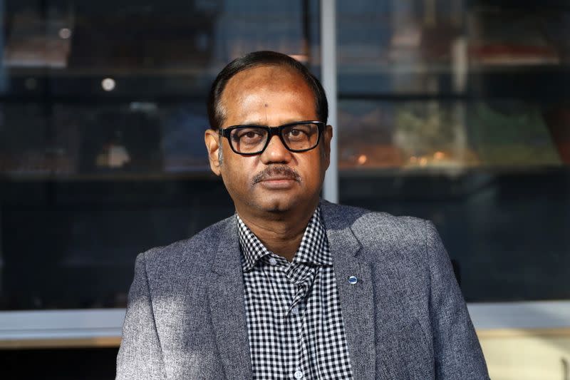 Shahidullah Azim, owner of a garment factory, poses for a portrait in his office in Dhaka