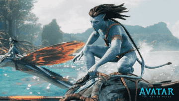 A member of the Na' vi riding a creature in the water in Avatar: The Way of Water