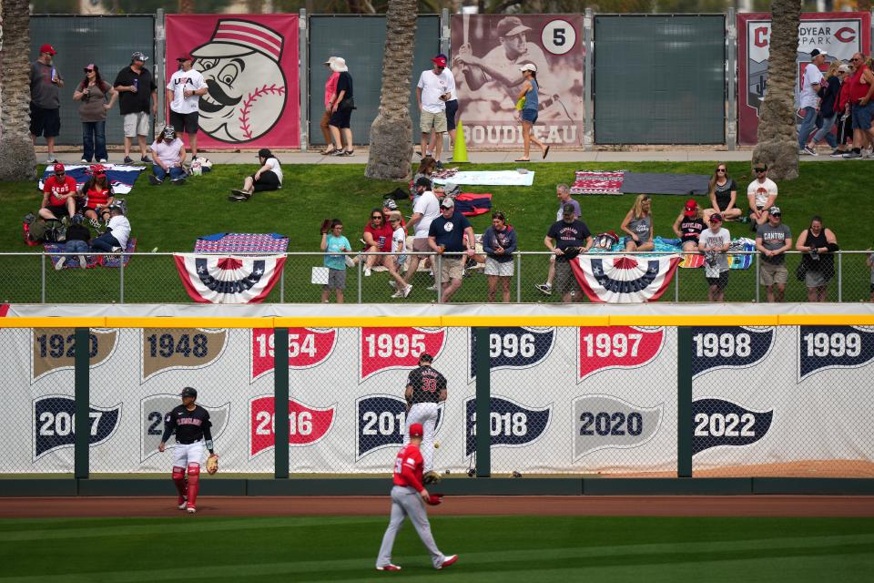 Baseball fans settle into the outfield lawn before the spring baseball game between the Cleveland Guardians, during a MLB spring training baseball game, Saturday, Feb. 24, 2024, at Goodyear Ballpark in Goodyear, Ariz.