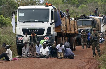 Muslim men fleeing sectarian violence from the capital Bangui pray on the road during a break in a convoy escorted by French peacekeepers as they head towards Bambari April 20, 2014. REUTERS/Emmanuel Braun