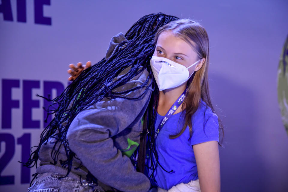 Swedish climate activist Greta Thunberg, right, is hugged by Ugandan climate activist Vanessa Nakate as they attend the start of a three-day Youth for Climate summit in Milan, Italy, Tuesday, Sept. 28, 2021. (Claudio Furlan/LaPresse via AP)