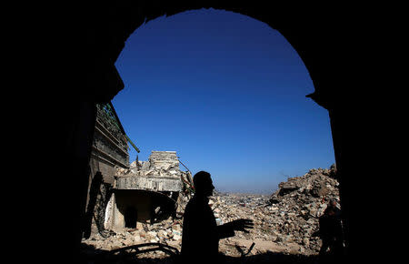 People gather at the destroyed tomb of the Prophet Jonah (Nabi Younes) in the eastern side of Mosul, Iraq March 9, 2017. REUTERS/Suhaib Salem