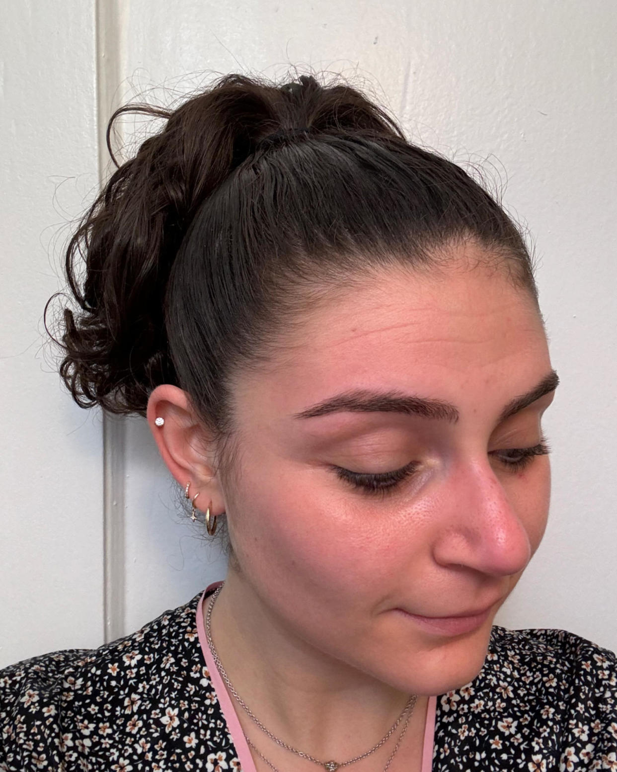 Woman shows a frizz-free curly up-do after using the wax stick. (Courtesy Zoe Malin)