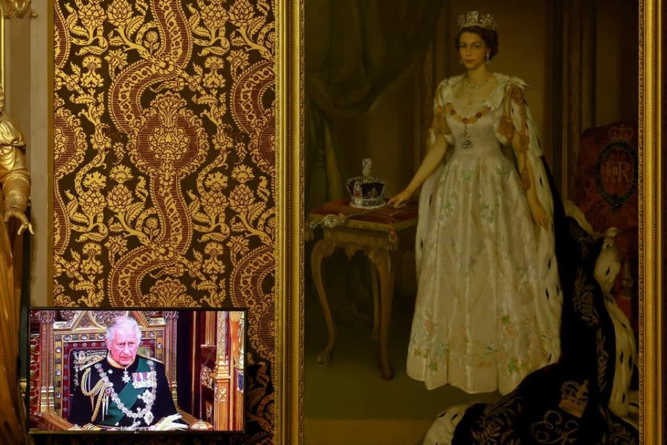 A television screen next to a painting of the Queen in the Royal Gallery shows the Prince of Wales reading the Queen&#x002019;s Speech (Hannah McKay/PA) (PA Wire)