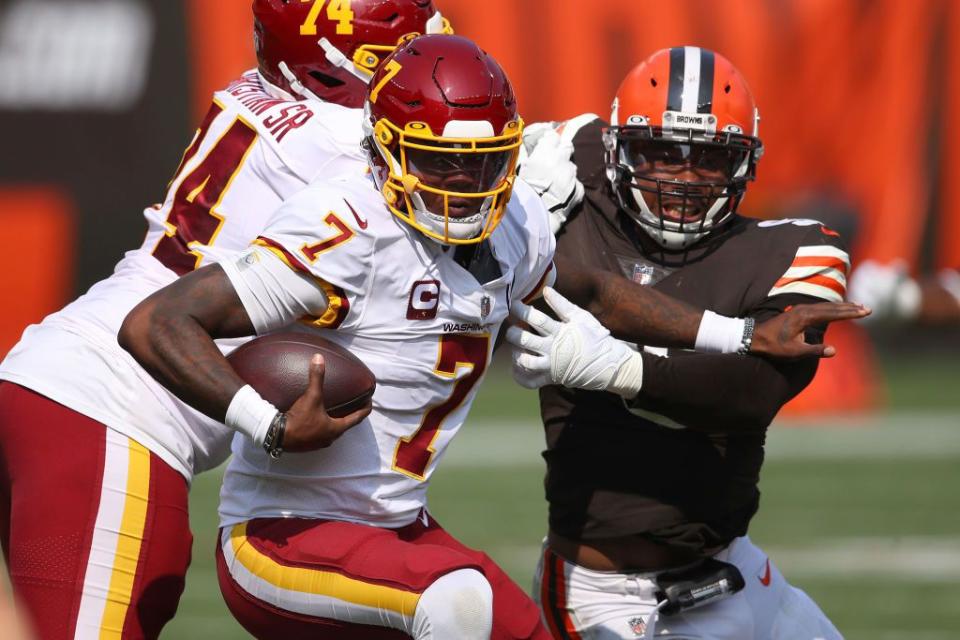 CLEVELAND, OHIO - SEPTEMBER 27: Dwayne Haskins #7 of the Washington Football Team tries to avoid a tackle while playing the Cleveland Browns at FirstEnergy Stadium on September 27, 2020 in Cleveland, Ohio. Cleveland won the game 34-20. (Photo by Gregory Shamus/Getty Images)