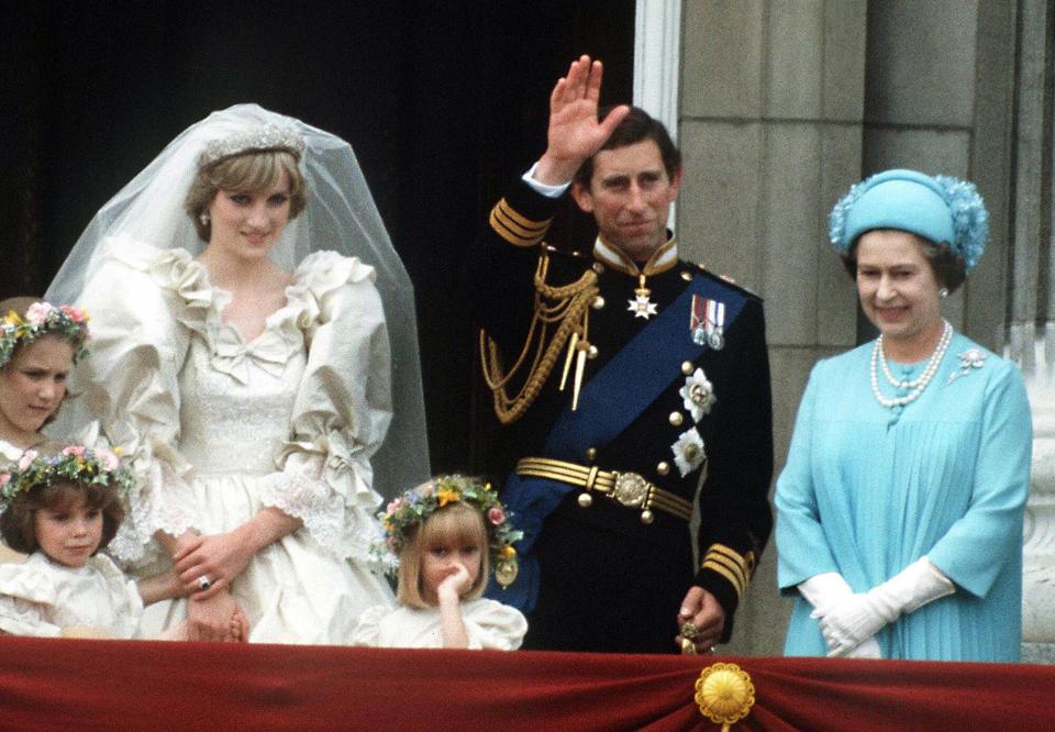 The Prince and Princess of Wales pose on the balcony of Buckingham Palace on their wedding day, with the Queen and some of the bridesmaids, 29th July 1981
