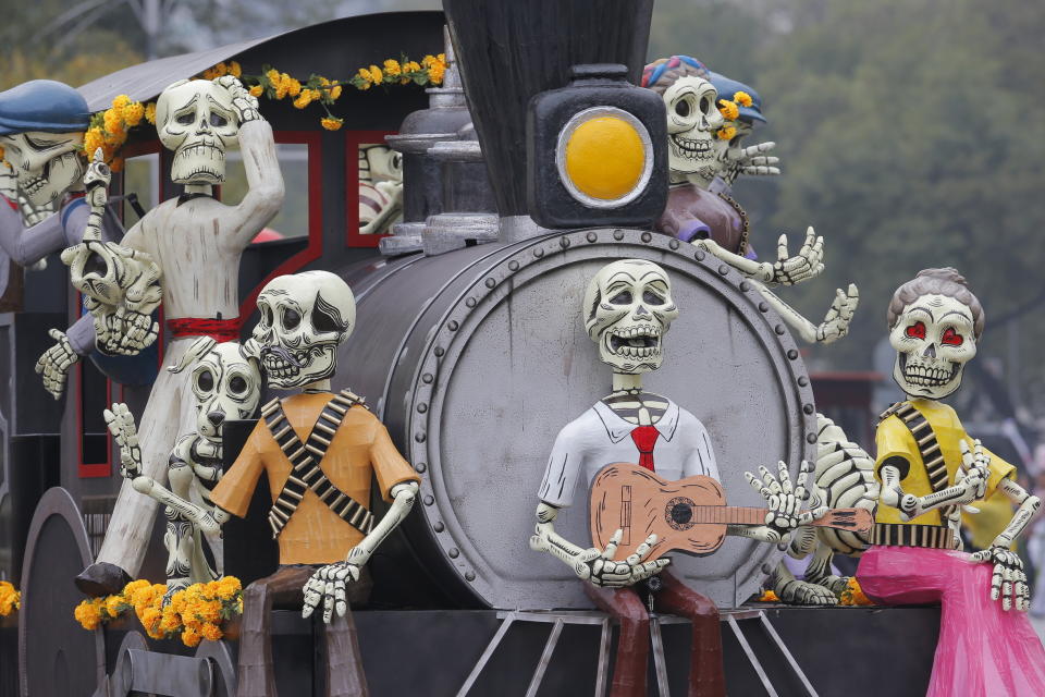 Day of the Dead sculptures join a parade in Mexico City, Saturday, Nov. 2, 2019. (AP Photo/Ginnette Riquelme)